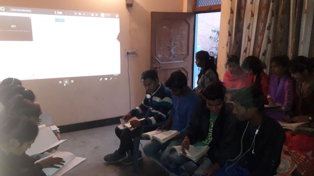 Students following a projected lesson at the Faridabad Centre